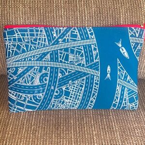 Blue and White Emirates Toiletry Bag with travel necessities and a Dubai flyer